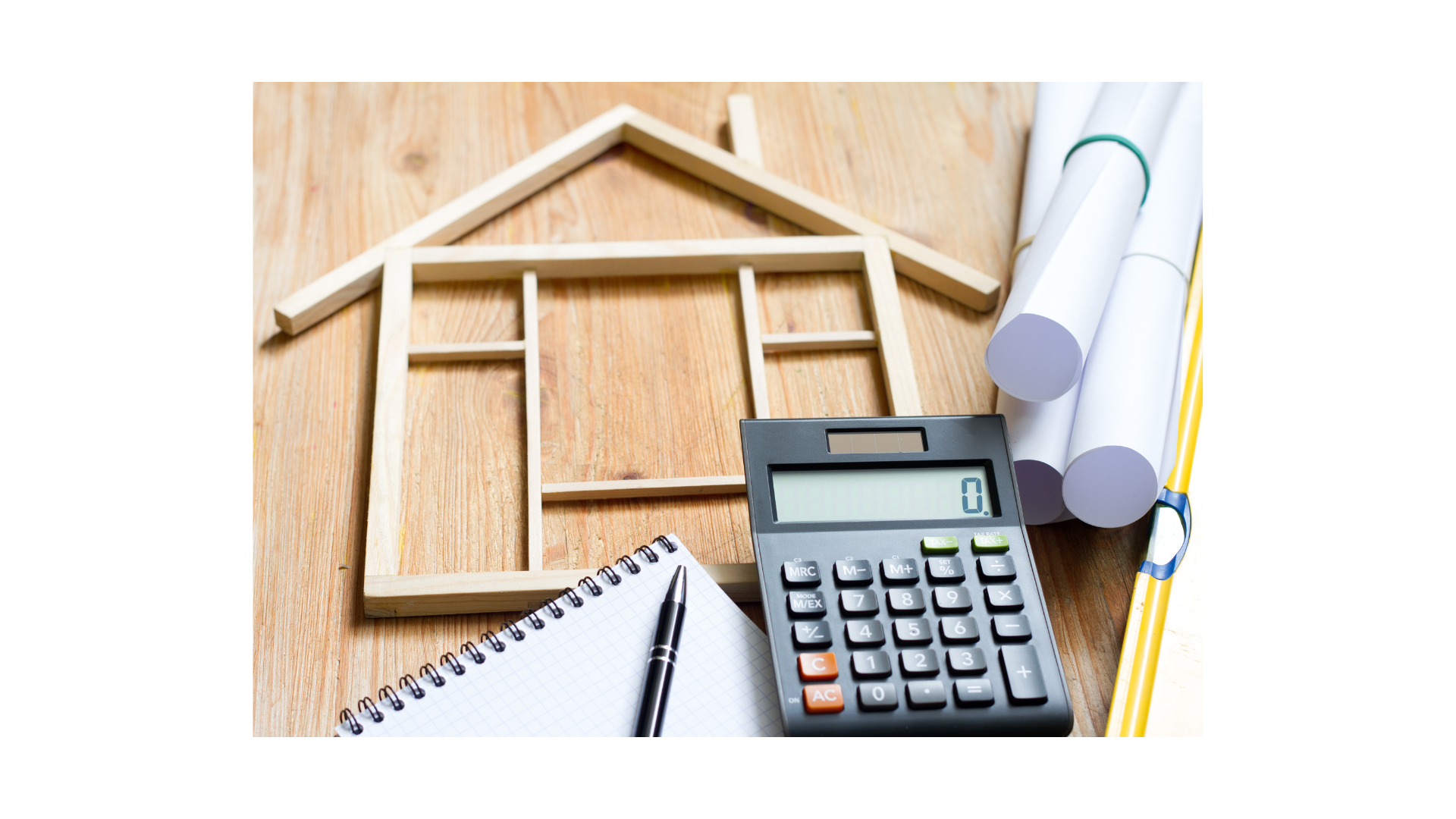 Home buying budget planning with calculator and house frame